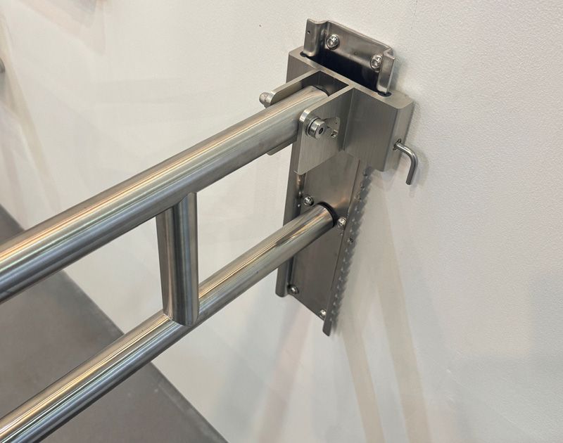 Vandal-resistant foldable toilet safety bar for high-traffic public toilets